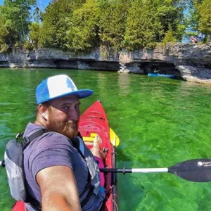 Kayaker taking photo of himself on Lake Michigan