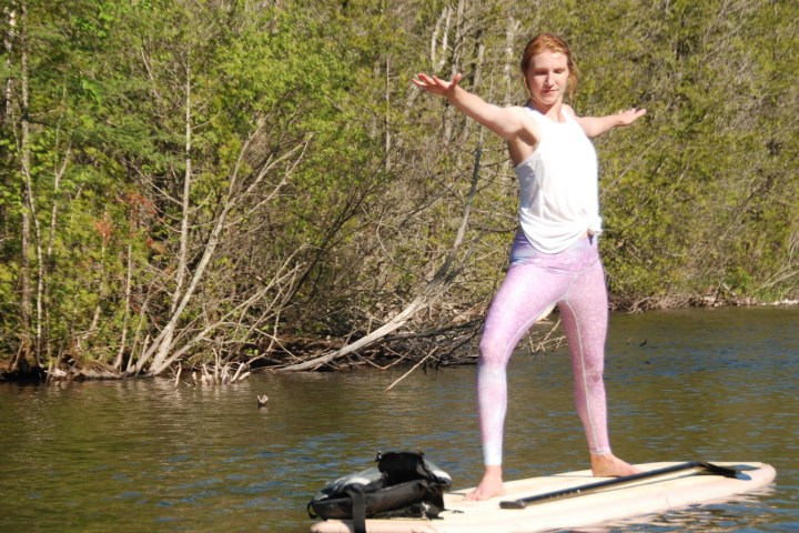 A woman doing yoga on a SUP
